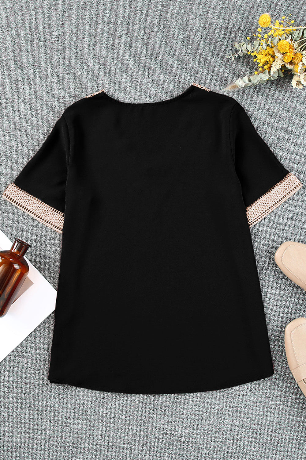 Plus size black V-neck short sleeve blouse with eyelet detailing and flounce sleeves